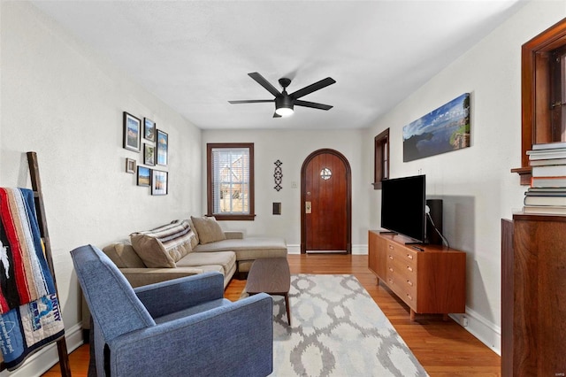 living room featuring ceiling fan and light hardwood / wood-style floors