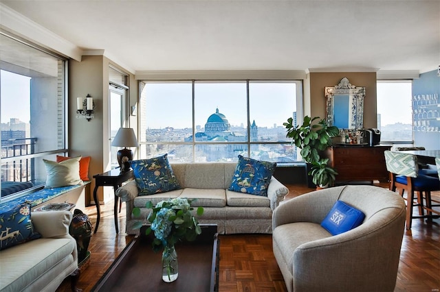 living room with dark parquet flooring, ornamental molding, and expansive windows