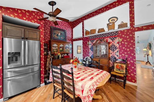 dining room with ceiling fan and light hardwood / wood-style flooring