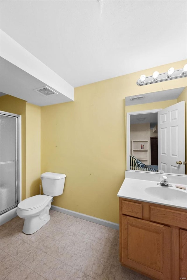 bathroom with vanity, toilet, and an enclosed shower