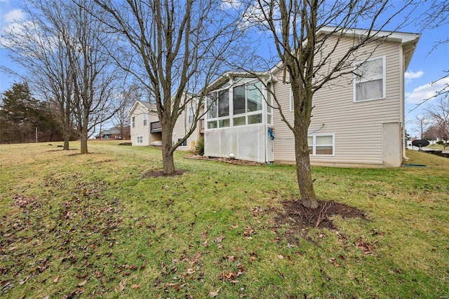 exterior space with a sunroom and a yard