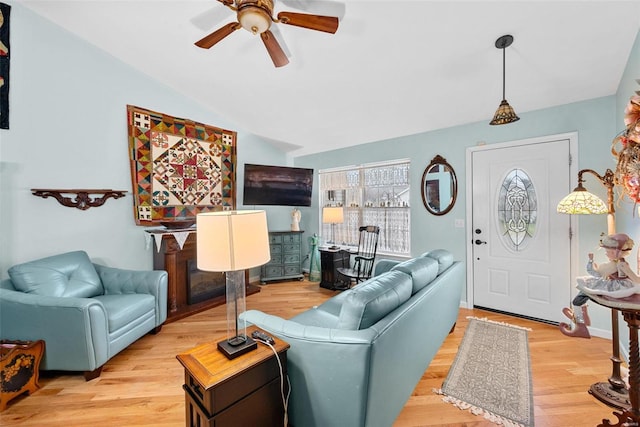 living room with vaulted ceiling, light hardwood / wood-style floors, and ceiling fan