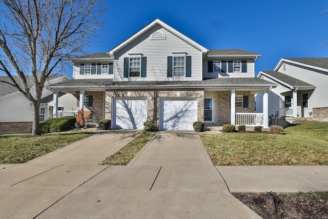 view of front facade featuring a garage, a front yard, and a porch