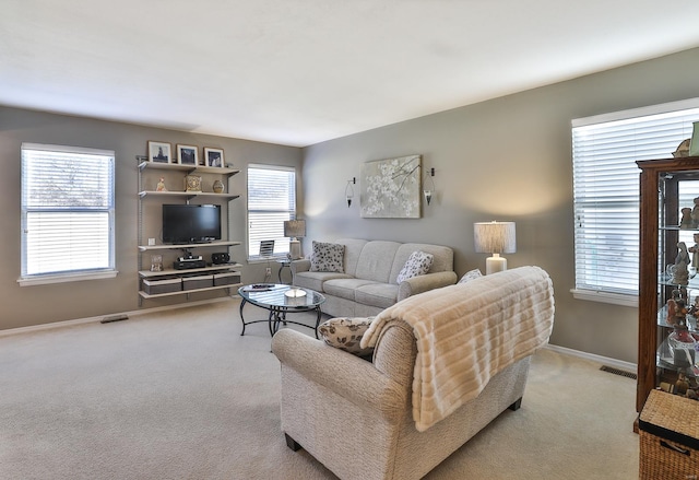 living room with a wealth of natural light and light colored carpet