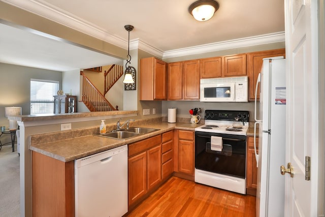 kitchen featuring sink, crown molding, white appliances, decorative light fixtures, and kitchen peninsula