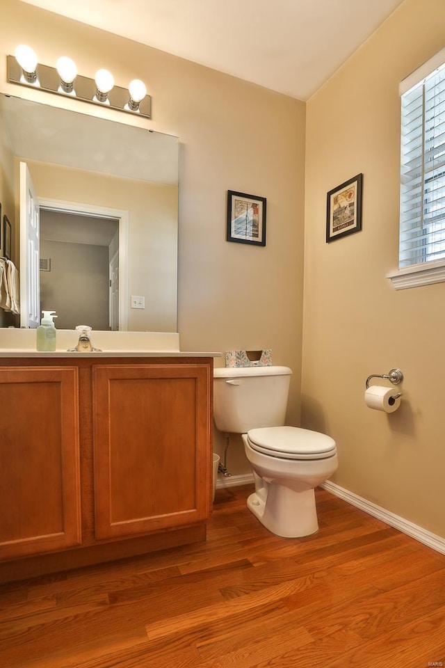 bathroom featuring vanity, hardwood / wood-style floors, and toilet