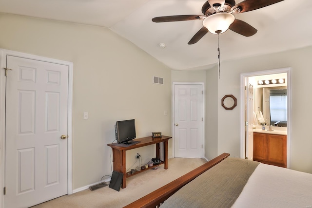 carpeted bedroom featuring ensuite bath, vaulted ceiling, and ceiling fan