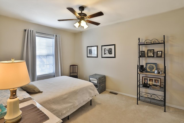 bedroom with light carpet and ceiling fan