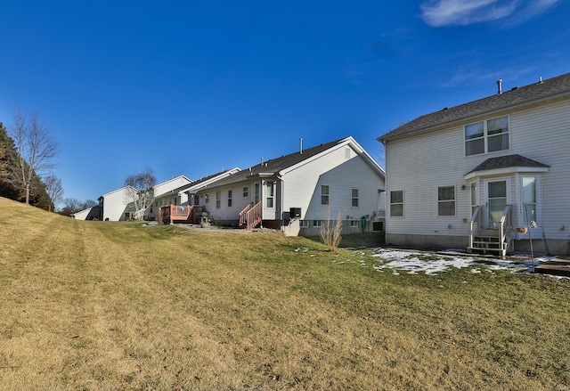 rear view of property featuring a yard