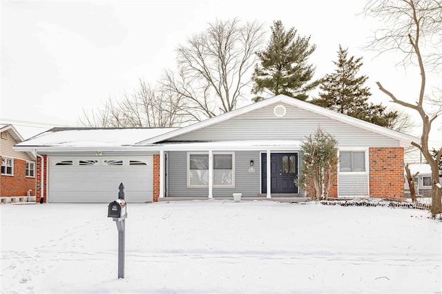 single story home with a garage and brick siding