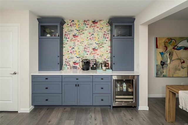 bar with wine cooler and dark hardwood / wood-style floors