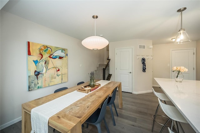 dining area with dark hardwood / wood-style floors