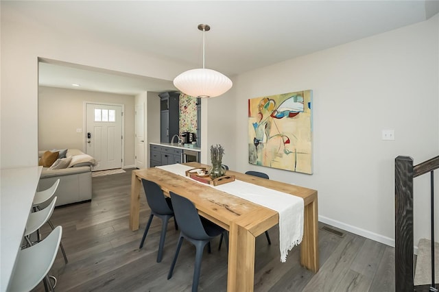 dining area with dark hardwood / wood-style flooring