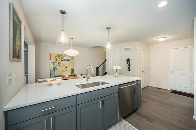 kitchen with sink, gray cabinetry, decorative light fixtures, stainless steel dishwasher, and dark hardwood / wood-style flooring