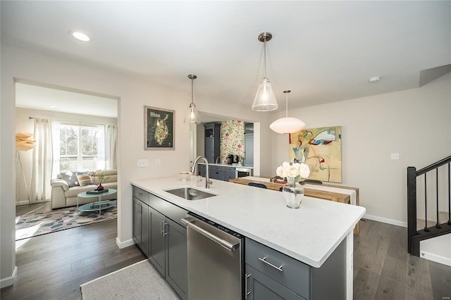 kitchen with gray cabinetry, sink, stainless steel dishwasher, and decorative light fixtures