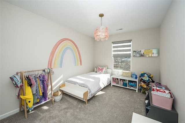 bedroom featuring an inviting chandelier and carpet floors