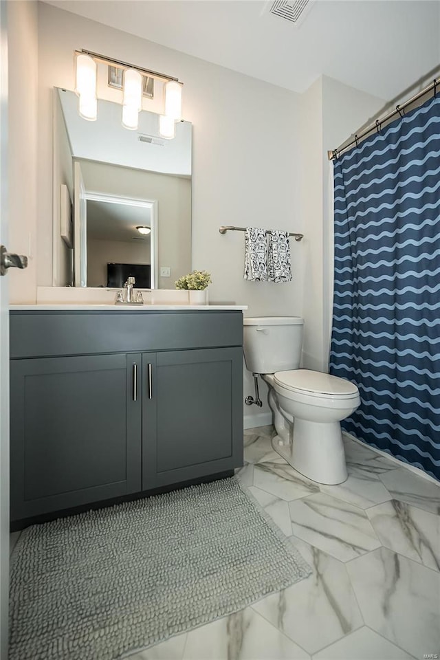 bathroom featuring vanity and toilet