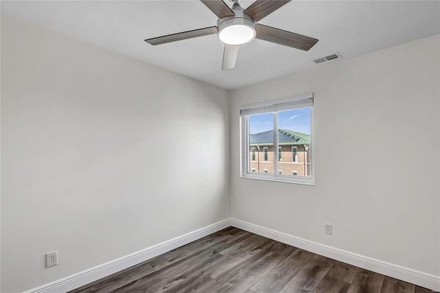 spare room with ceiling fan and dark hardwood / wood-style flooring