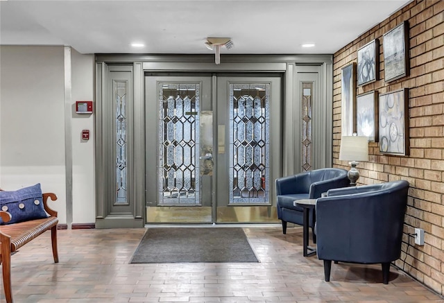 interior space with french doors and brick wall