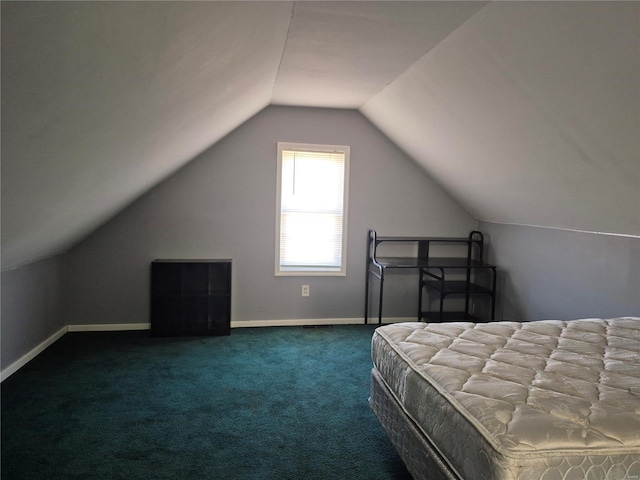 bedroom with carpet flooring, vaulted ceiling, and baseboards