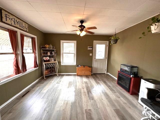 interior space with wood-type flooring and ceiling fan