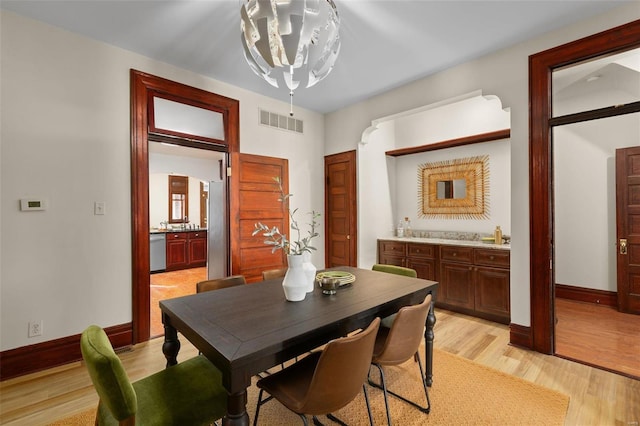 dining room featuring an inviting chandelier and light hardwood / wood-style floors