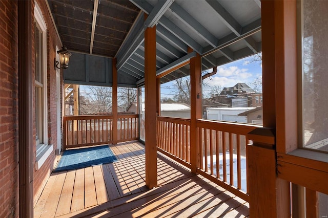 unfurnished sunroom with plenty of natural light and vaulted ceiling