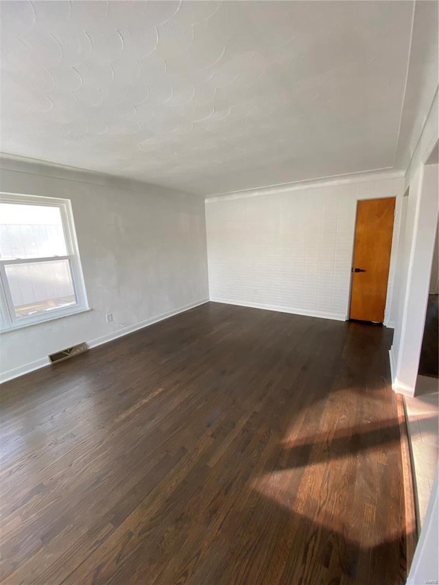 unfurnished room with dark hardwood / wood-style flooring