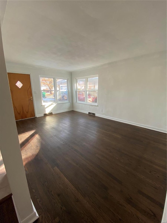 unfurnished living room featuring dark hardwood / wood-style flooring