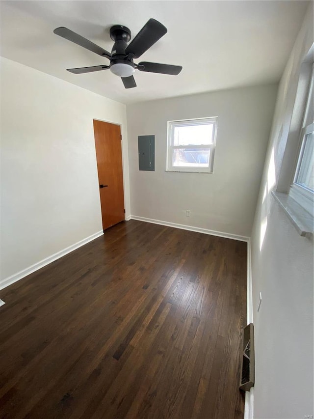 unfurnished room with dark hardwood / wood-style floors and electric panel