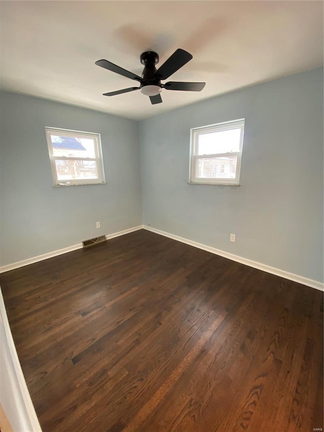 spare room featuring dark hardwood / wood-style floors and ceiling fan