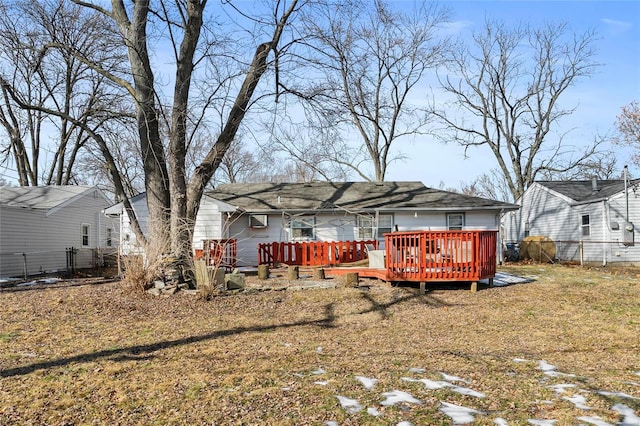 back of property with a lawn and a deck