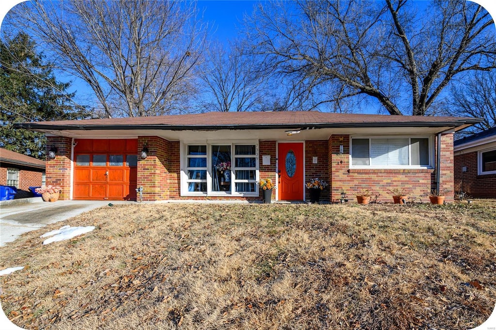 ranch-style home featuring a garage and a front yard