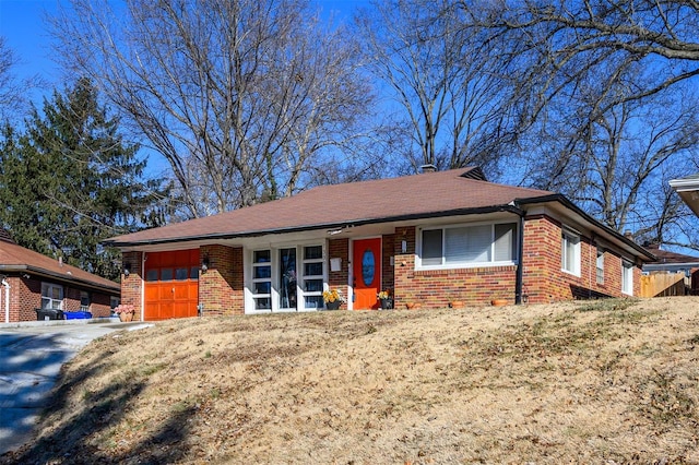 single story home featuring a garage and a front lawn