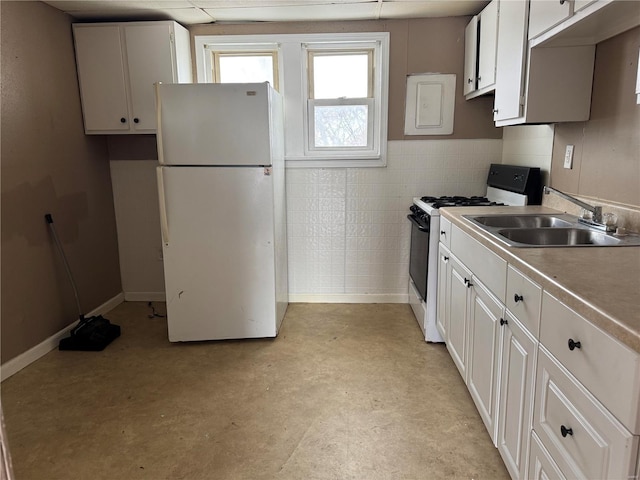 kitchen featuring tile walls, sink, white appliances, and white cabinets