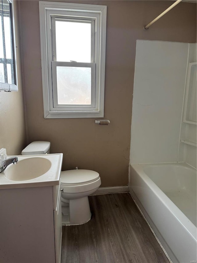 full bathroom with vanity, wood-type flooring, toilet, and a healthy amount of sunlight