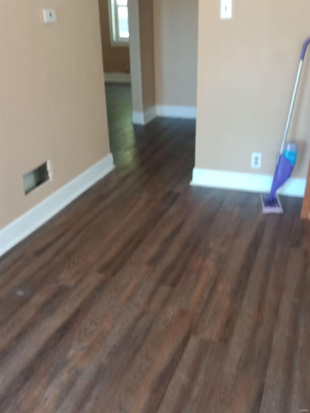 unfurnished room featuring dark wood-type flooring