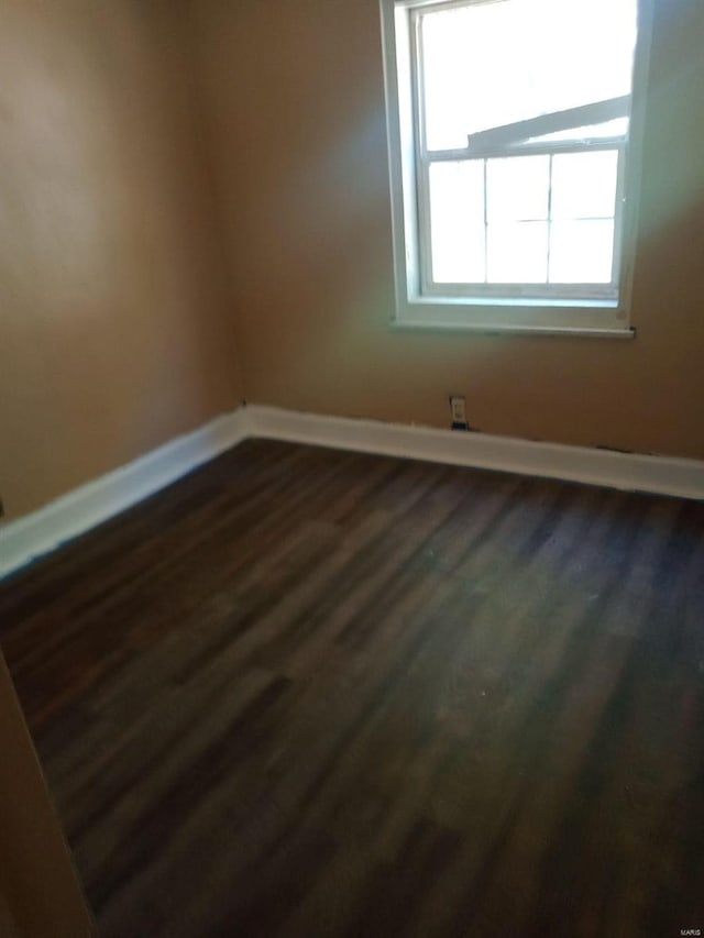 spare room with dark hardwood / wood-style floors