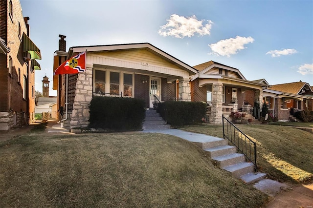 craftsman-style home with covered porch and a front yard