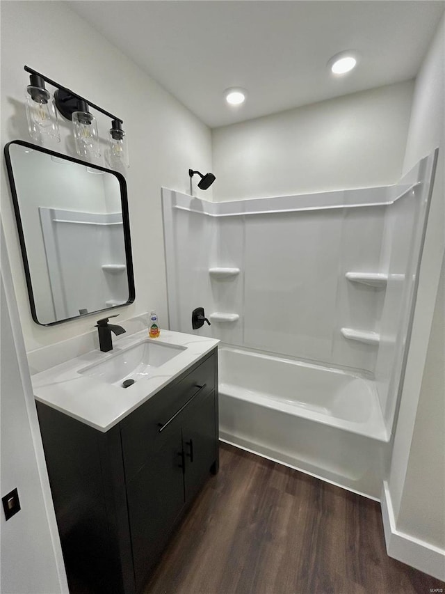 bathroom with vanity, hardwood / wood-style flooring, and bathtub / shower combination