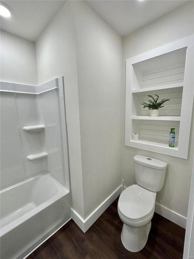 bathroom featuring wood-type flooring, shower / bathtub combination, and toilet