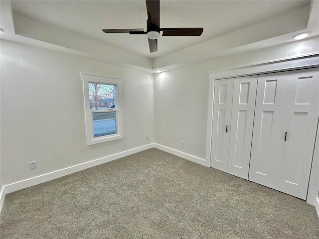 unfurnished bedroom featuring a closet, ceiling fan, and carpet