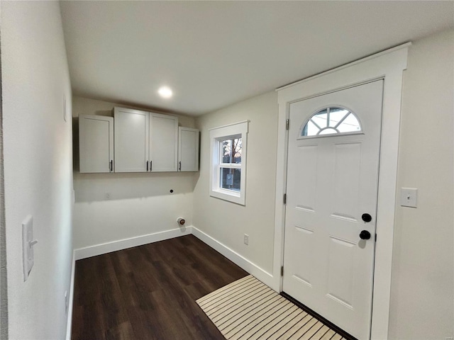 laundry area featuring cabinets, dark hardwood / wood-style floors, and electric dryer hookup