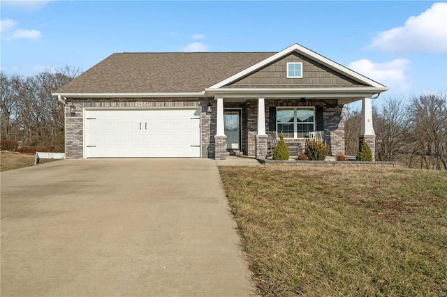 craftsman-style home with a garage, a front yard, and a porch