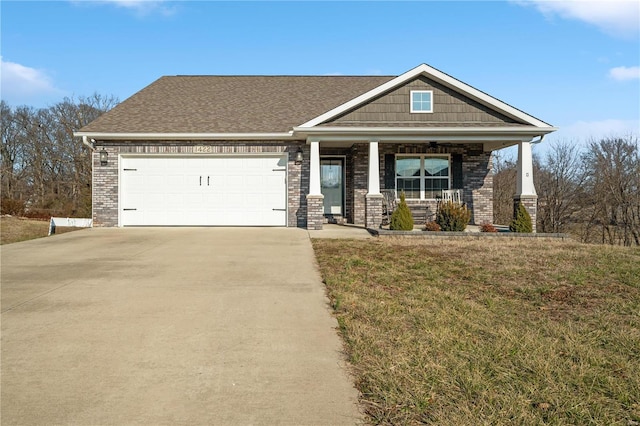 craftsman-style home with a garage, a front lawn, and covered porch