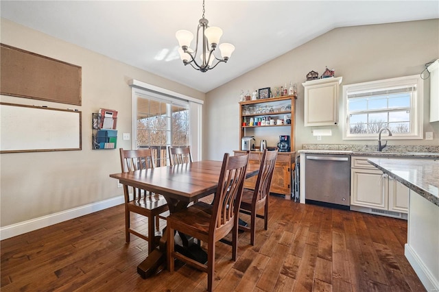 dining room with plenty of natural light, dark hardwood / wood-style floors, vaulted ceiling, and a notable chandelier