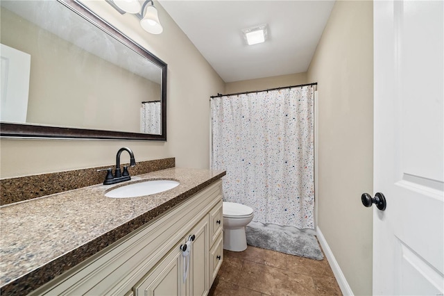 bathroom featuring vanity, tile patterned flooring, and toilet