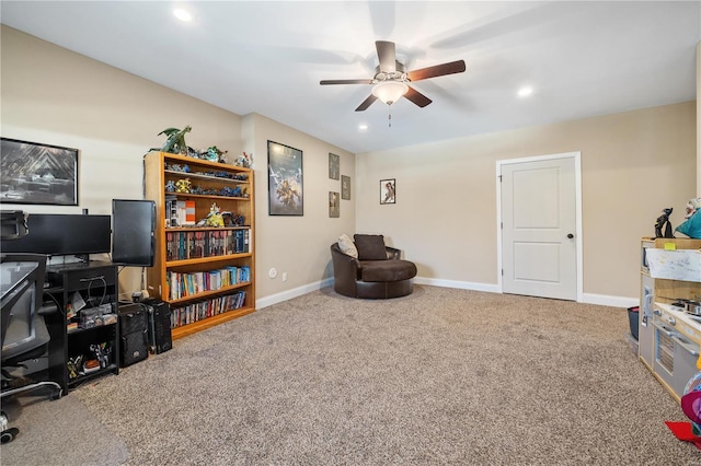 living area with ceiling fan and carpet flooring