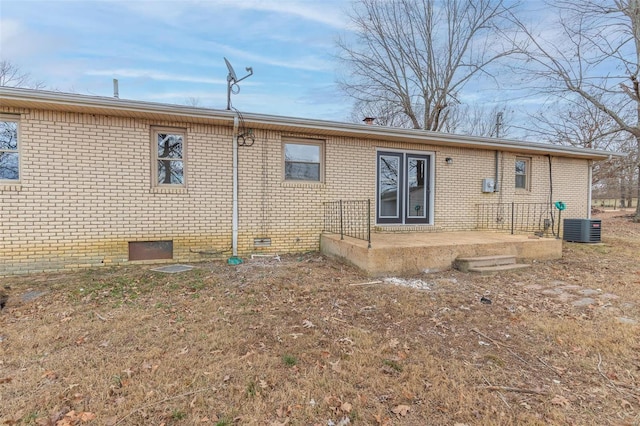 rear view of house with central AC and a patio area