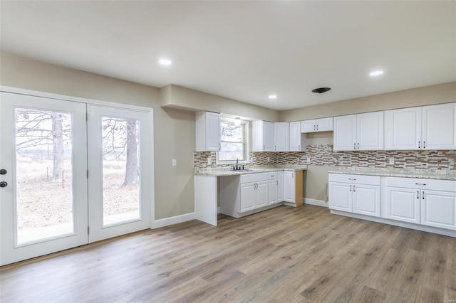 kitchen with white cabinetry and sink